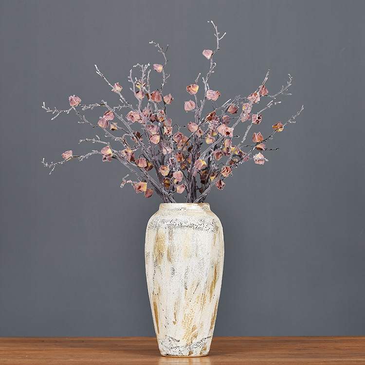 Frosted dried flowers with dead branches in winter